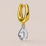 Gold hoop earring with a teardrop-shaped diamond pendant on a beige background