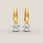 Gold hoop earrings with round gemstones on a beige background