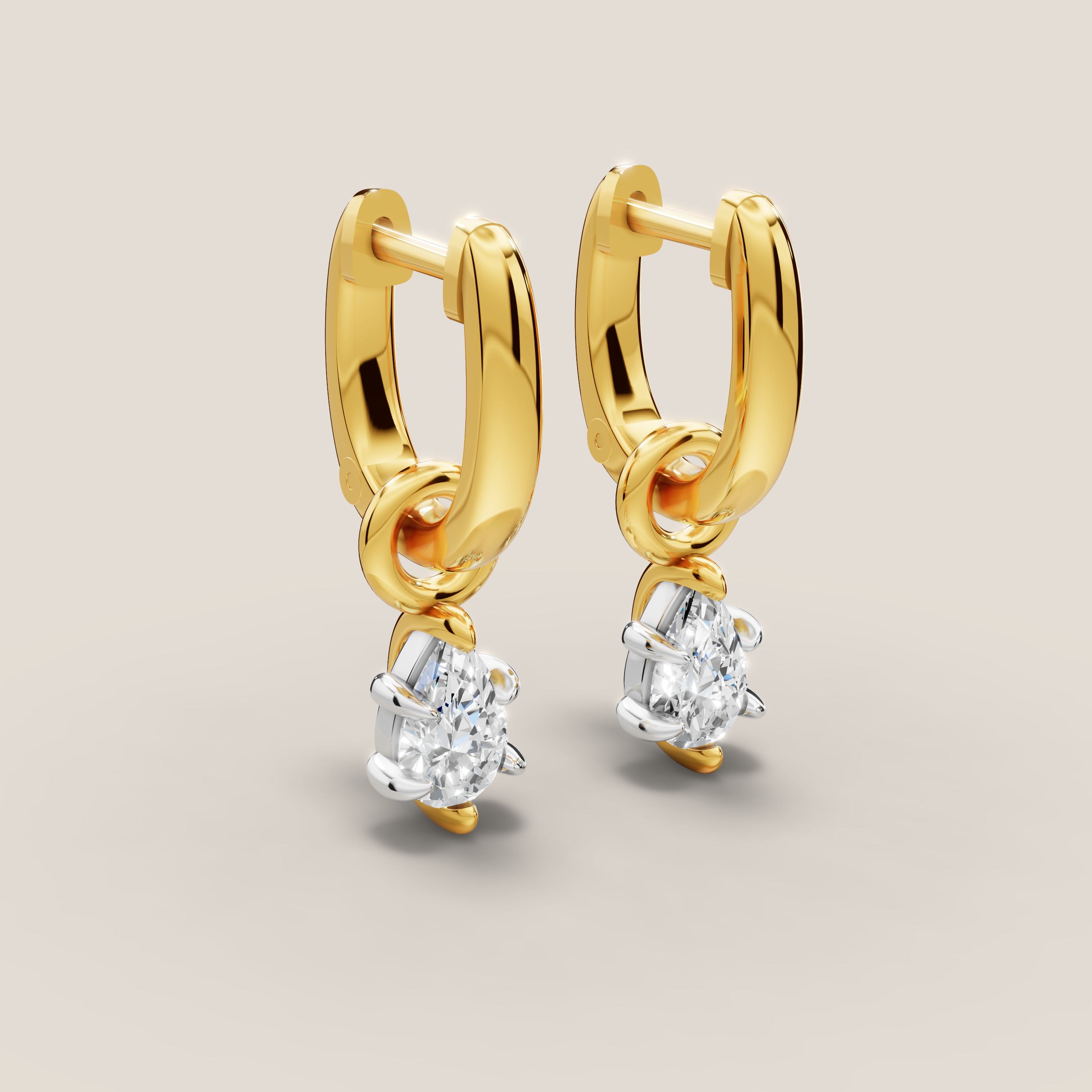 Gold hoop earrings with diamond drops on a beige background