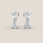 Pair of diamond earrings on a light beige background