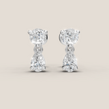 Pair of diamond earrings on a light beige background