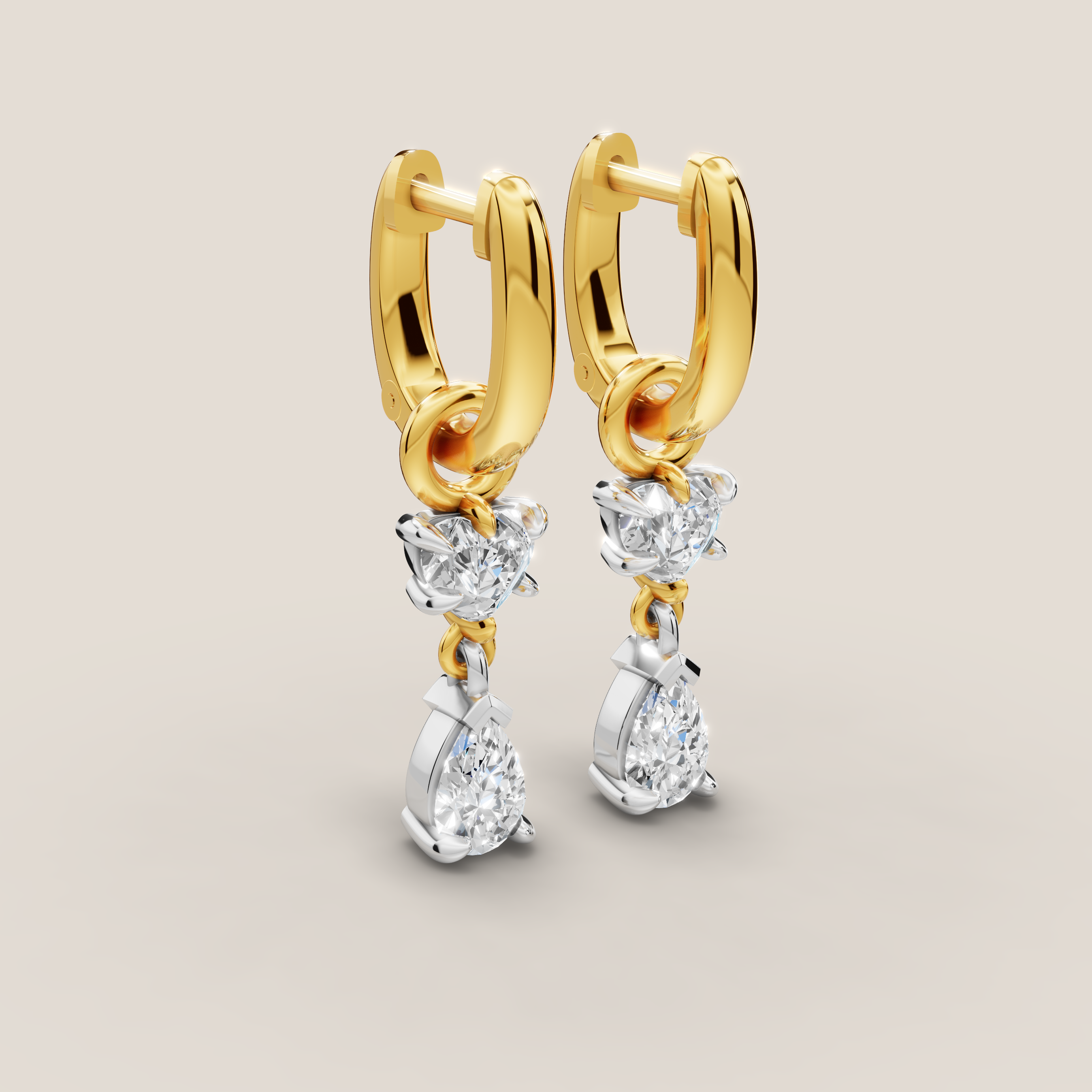 Gold hoop earrings with diamond drops on a beige background