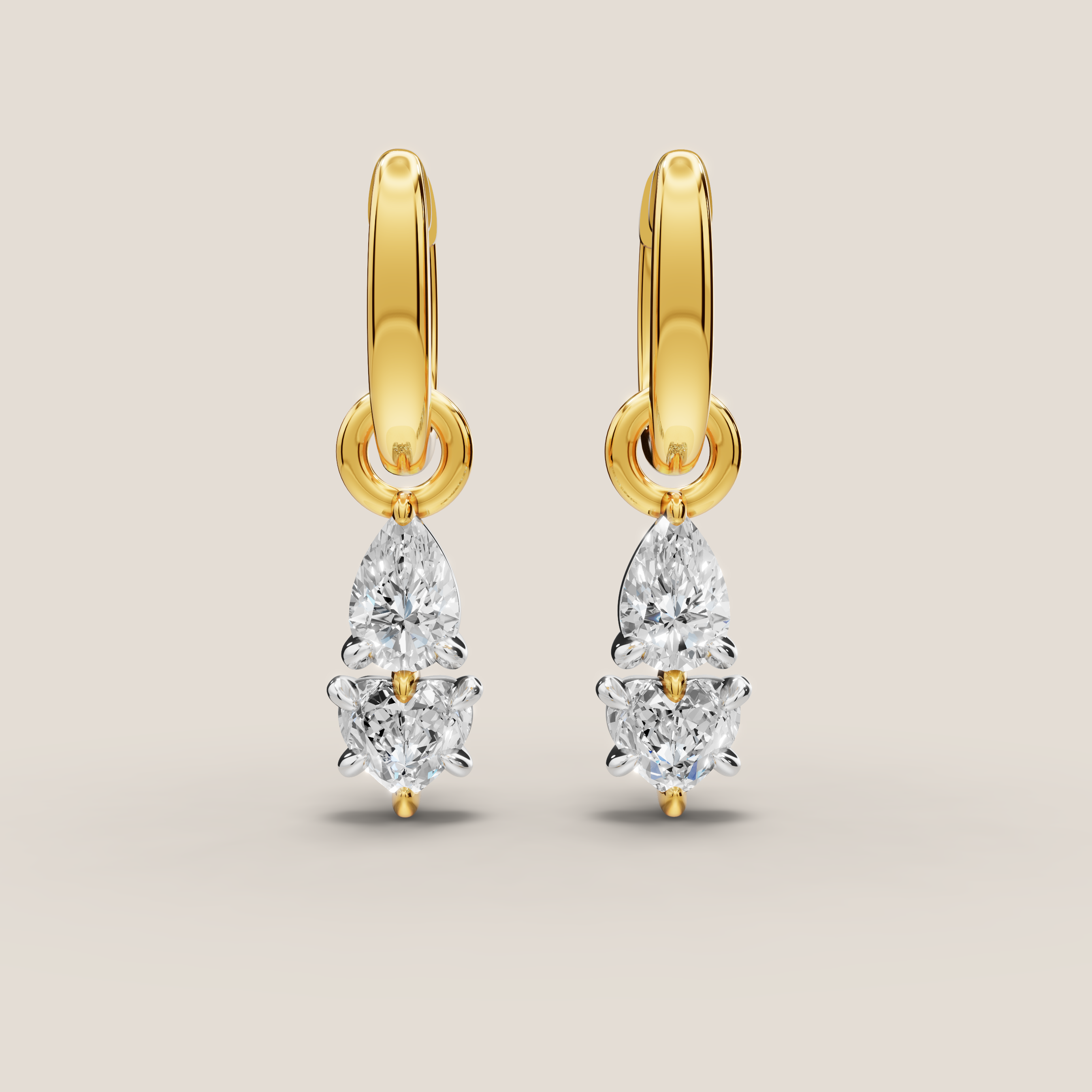 Gold earrings with teardrop-shaped diamonds on a beige background