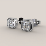 Pair of diamond stud earrings on a light gray background