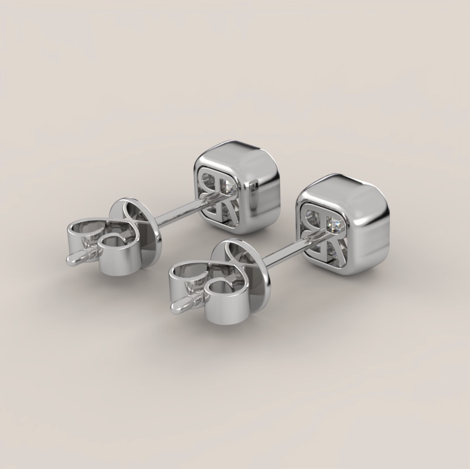 Pair of silver cube-shaped earrings on a light gray background
