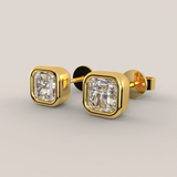 Gold earrings with diamond-like stones on a light gray background