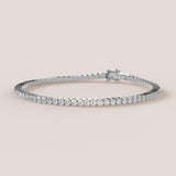 A tennis bracelet featuring lab-grown diamonds set in a 4-claw double bezel, crafted in 14k white gold.