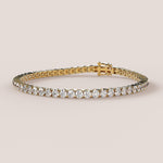 A tennis bracelet featuring lab-grown diamonds set in a 4-claw double bezel, crafted in 14k white gold.