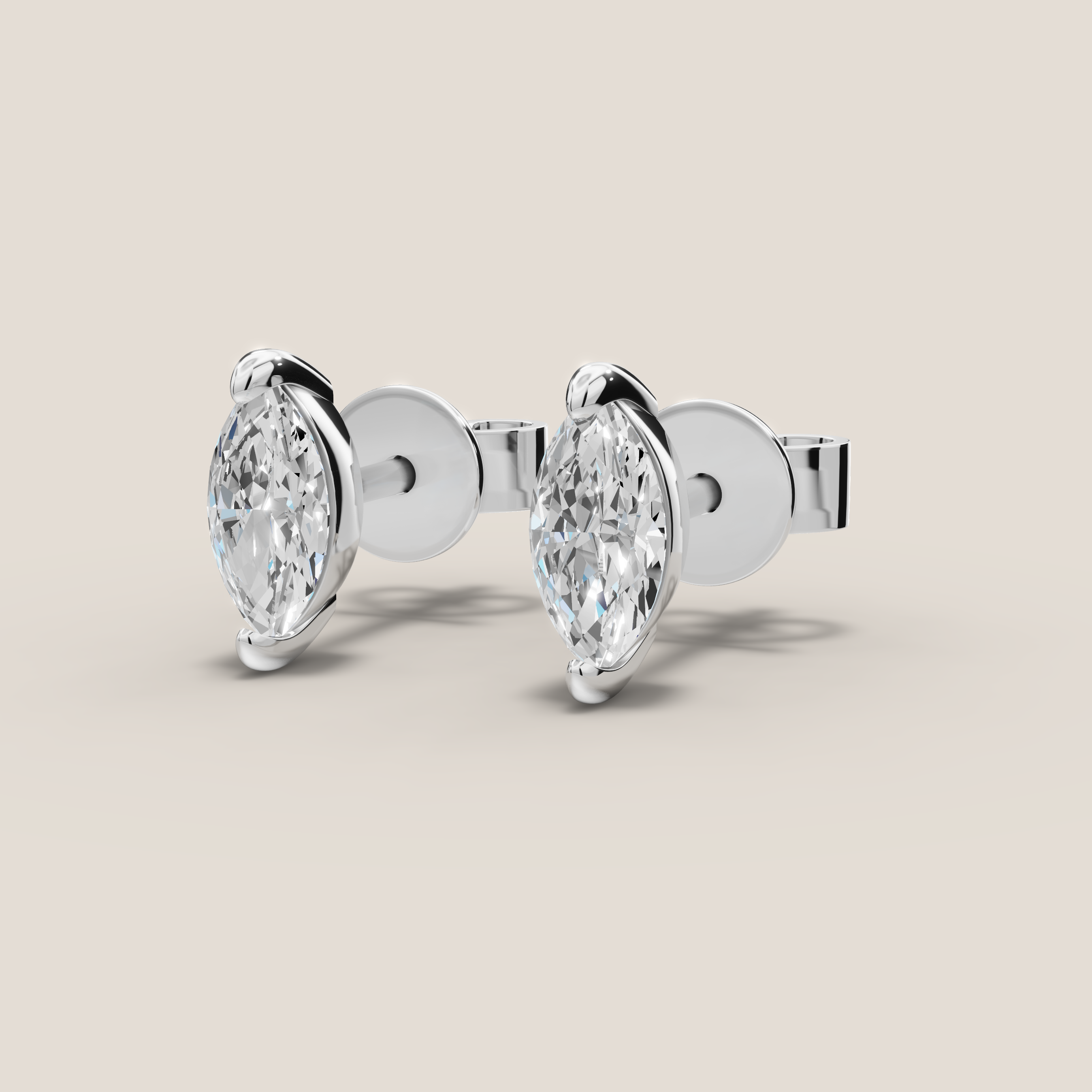 Pair of diamond earrings on a beige background