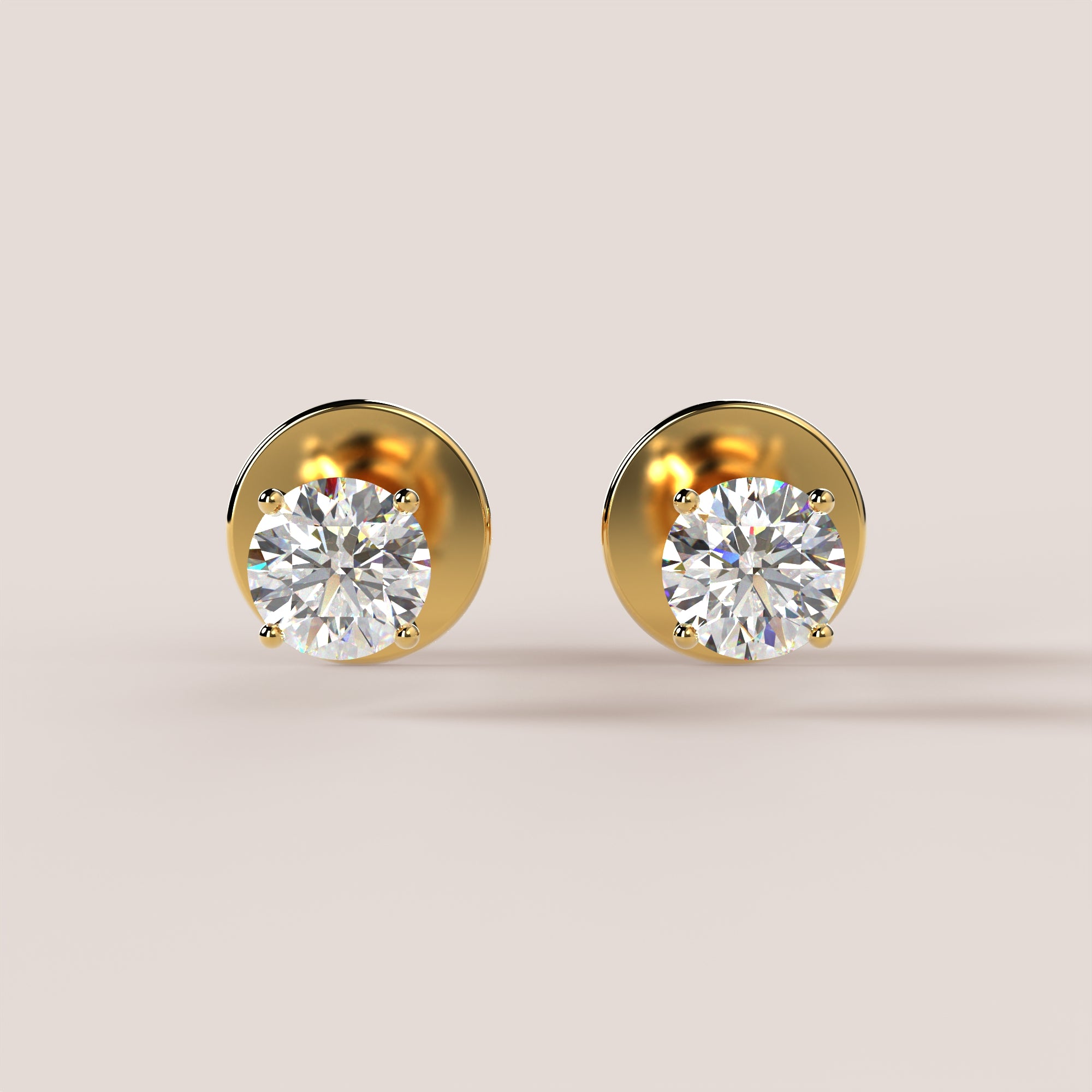 Gold earrings with clear gemstones on a beige background