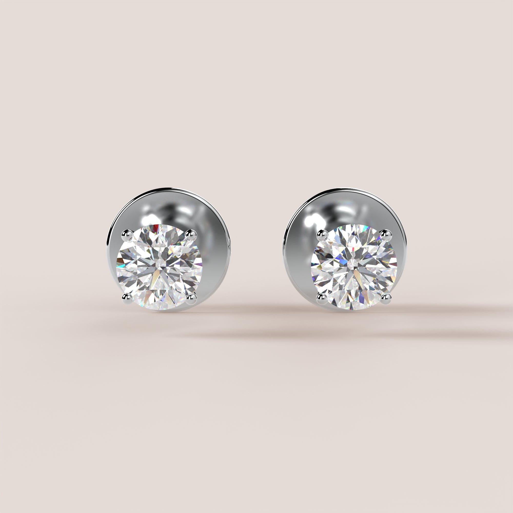 Pair of diamond stud earrings on a light beige background