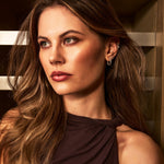 Woman with long brown hair in a wine cellar