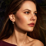 Woman wearing a burgundy dress with a dark background