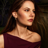 Woman wearing a burgundy dress with a dark background