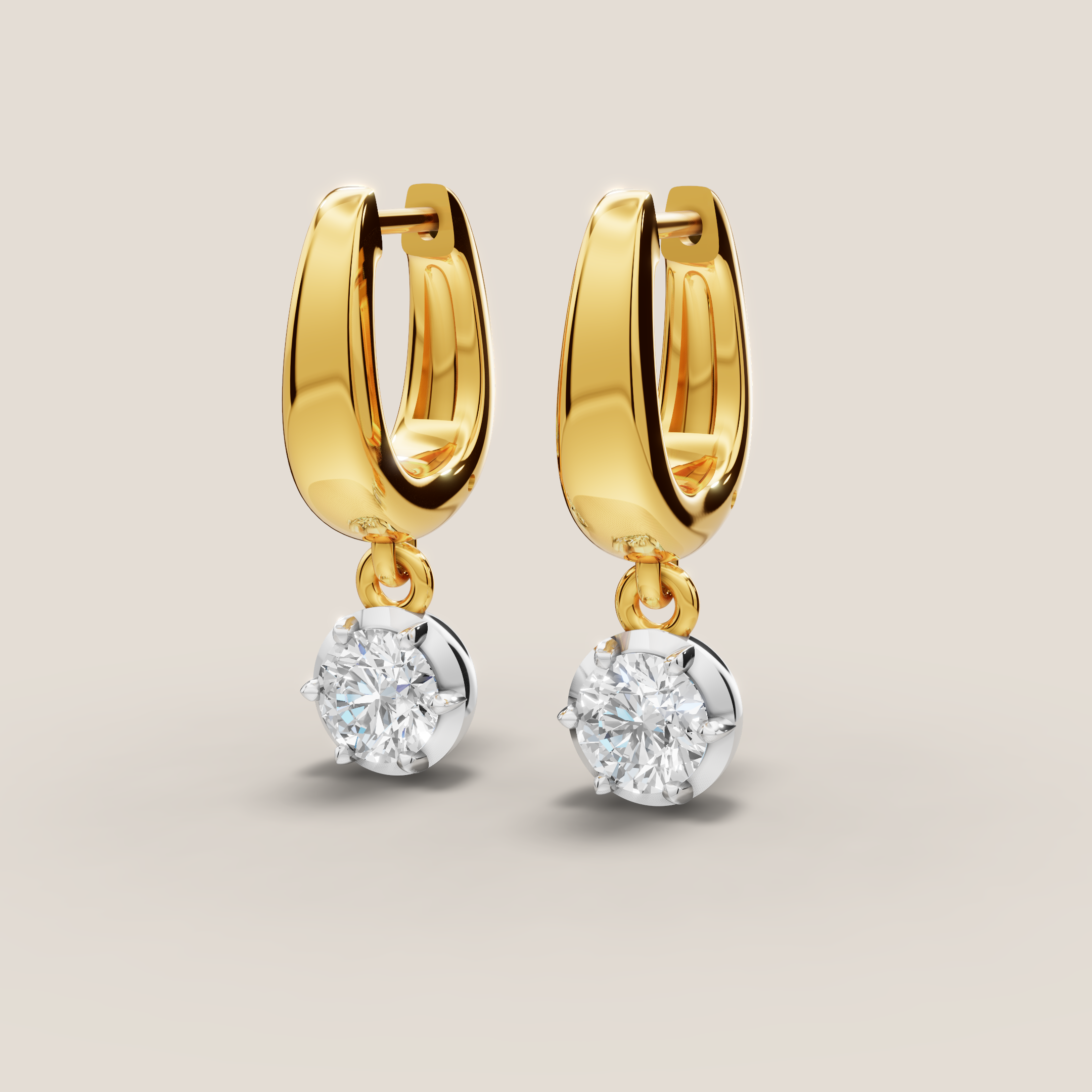 Gold hoop earrings with diamond drops on a light beige background